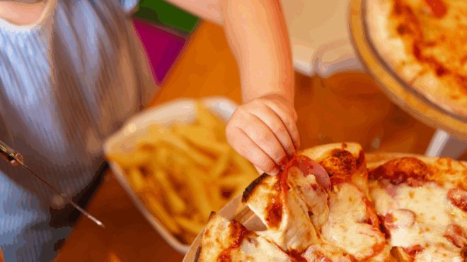 kid's hand reaching for pizza slice at birthday party